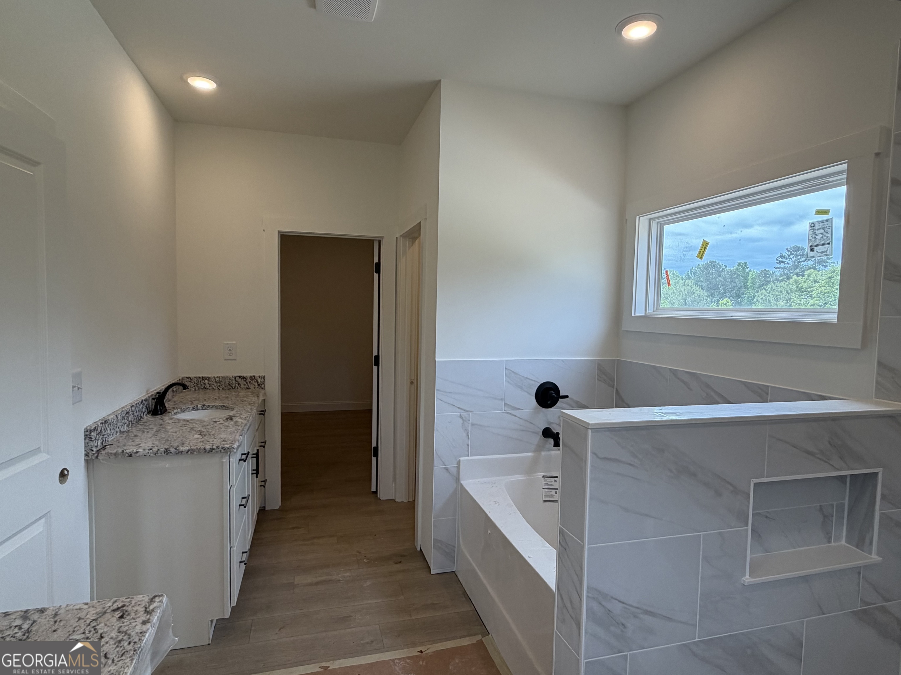 733 Pine Grove Culloden, GA 31016 - Photo 15 of 25 a bathroom with a granite countertop sink a toilet and bathtub