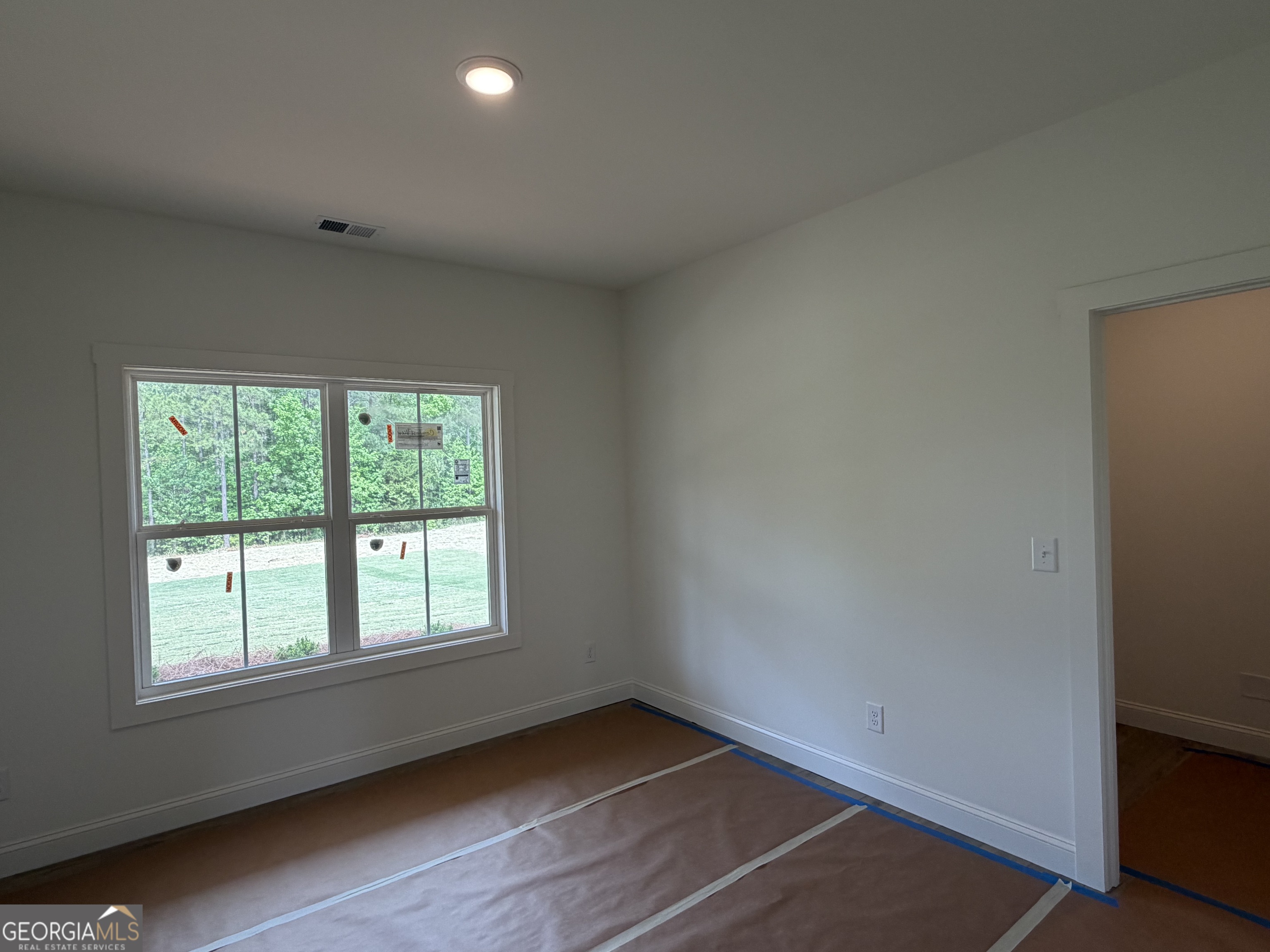 733 Pine Grove Culloden, GA 31016 - Photo 19 of 25 an empty room with wooden floor and windows
