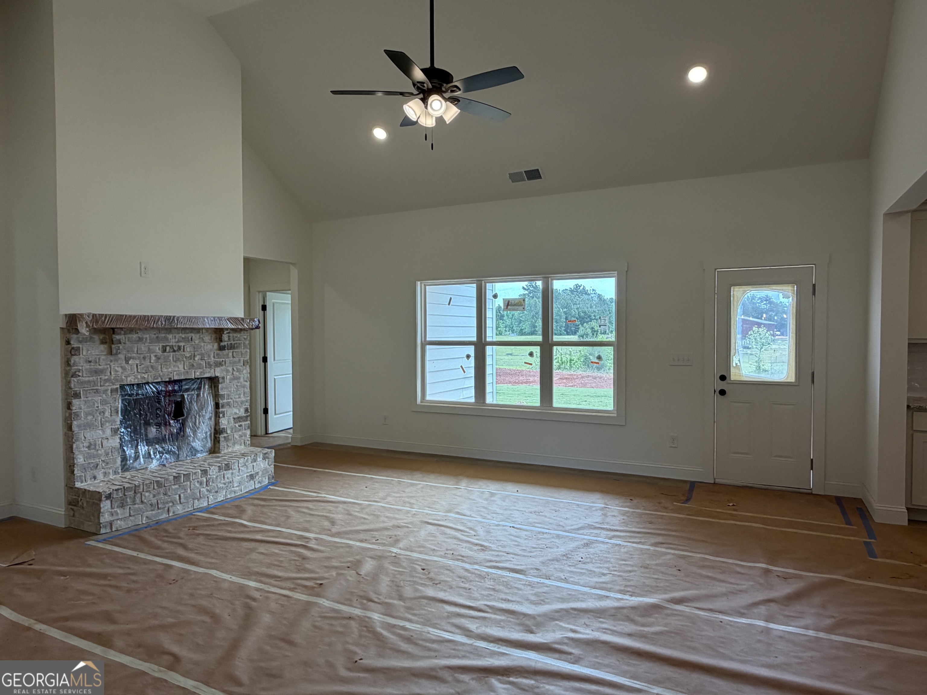 733 Pine Grove Culloden, GA 31016 - Photo 8 of 25 a view of an empty room with a fireplace and a window