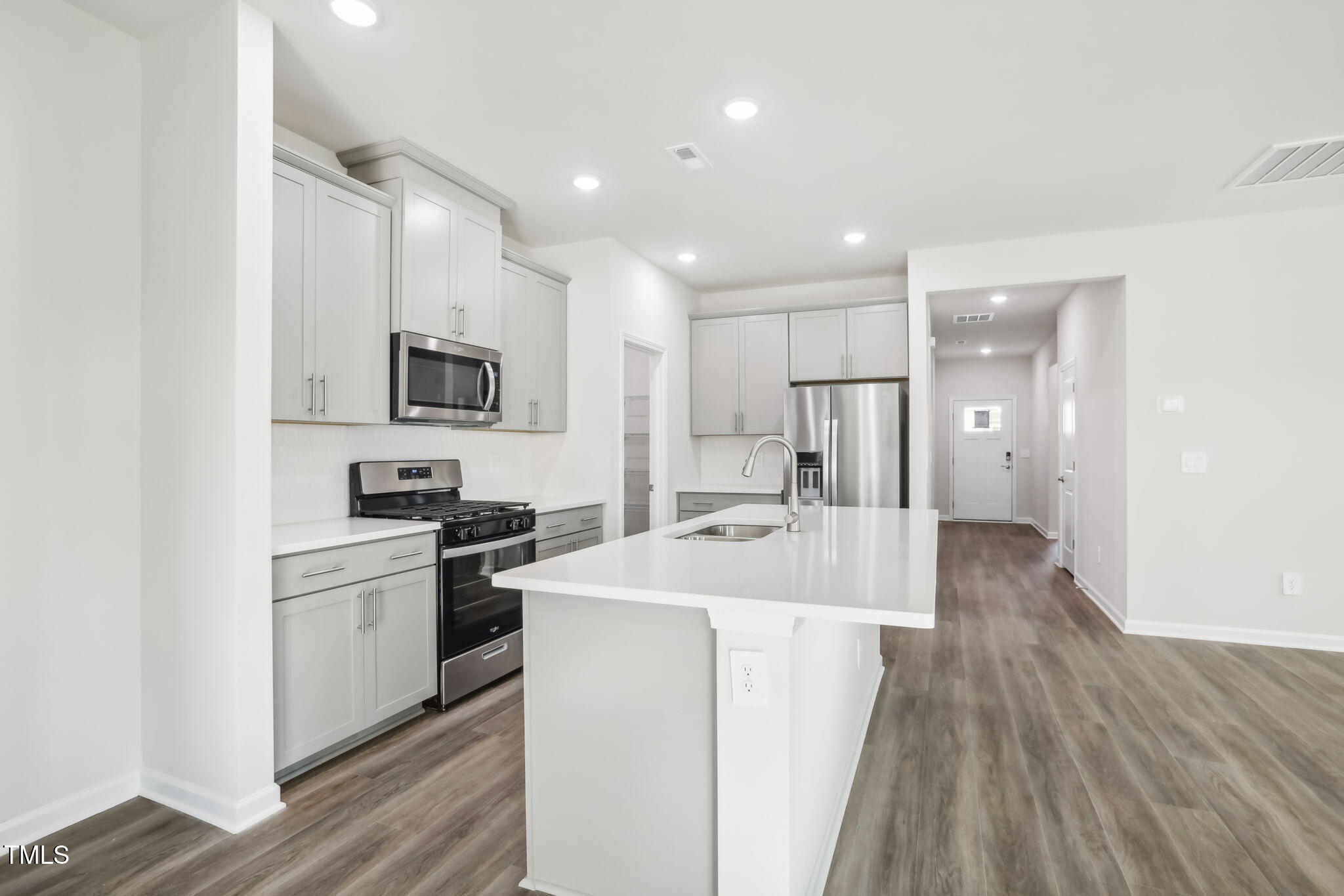 185 White Birch Lane Angier, NC 27501 - Photo 12 of 27 a kitchen with kitchen island a sink stainless steel appliances and cabinets