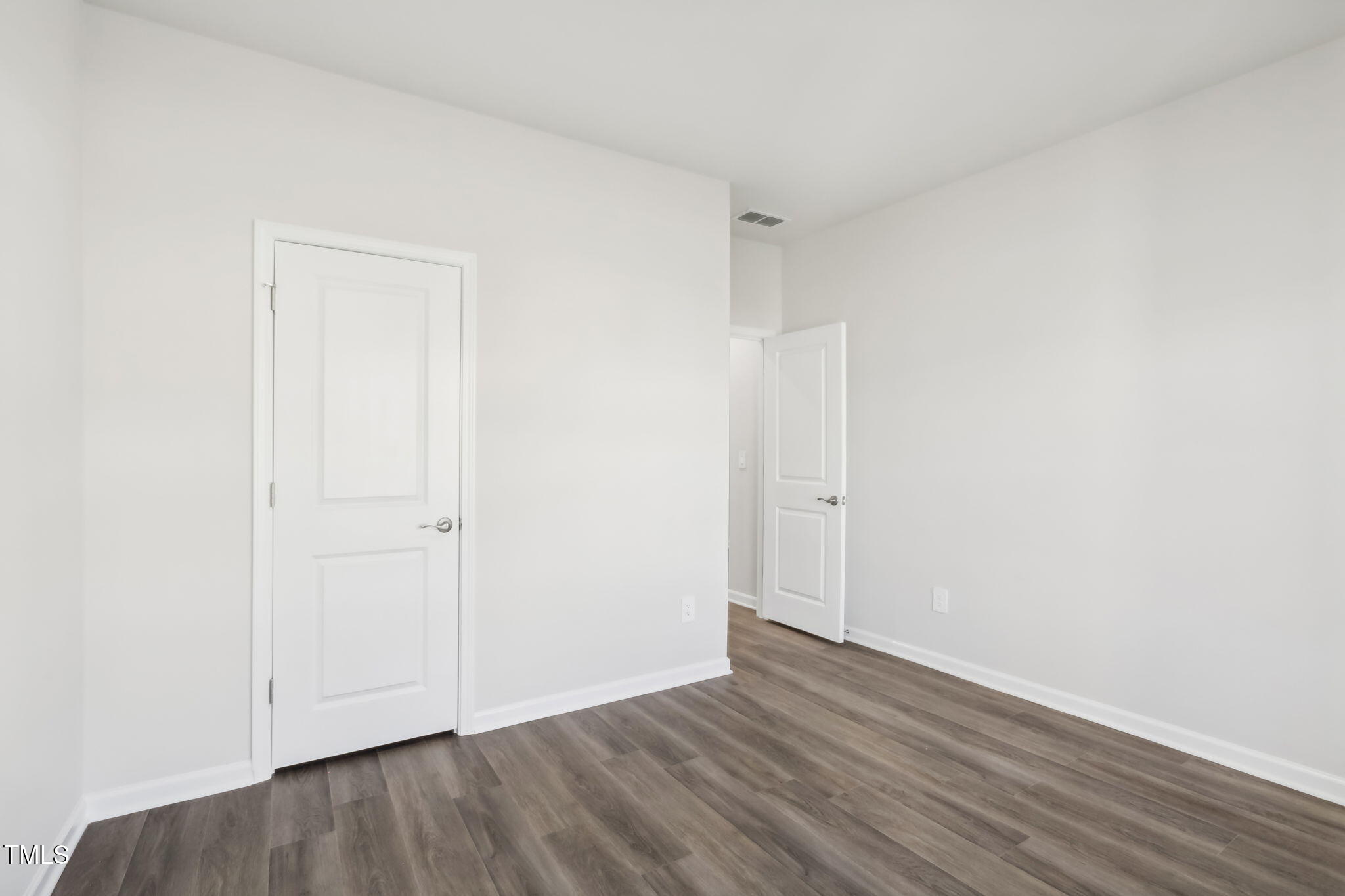 185 White Birch Lane Angier, NC 27501 - Photo 15 of 27 a view of an empty room with wooden floor