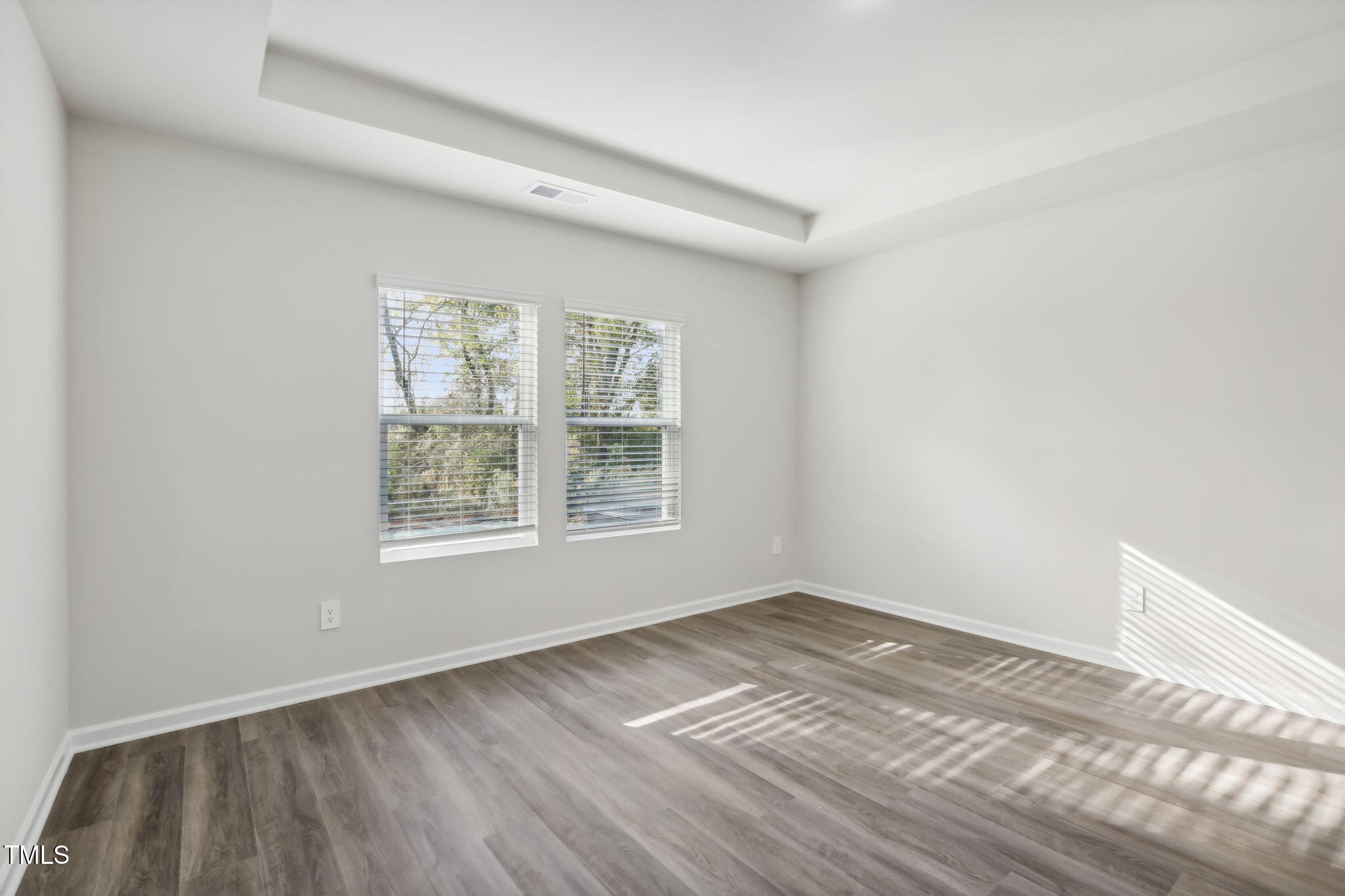 185 White Birch Lane Angier, NC 27501 - Photo 19 of 27 an empty room with wooden floor and windows