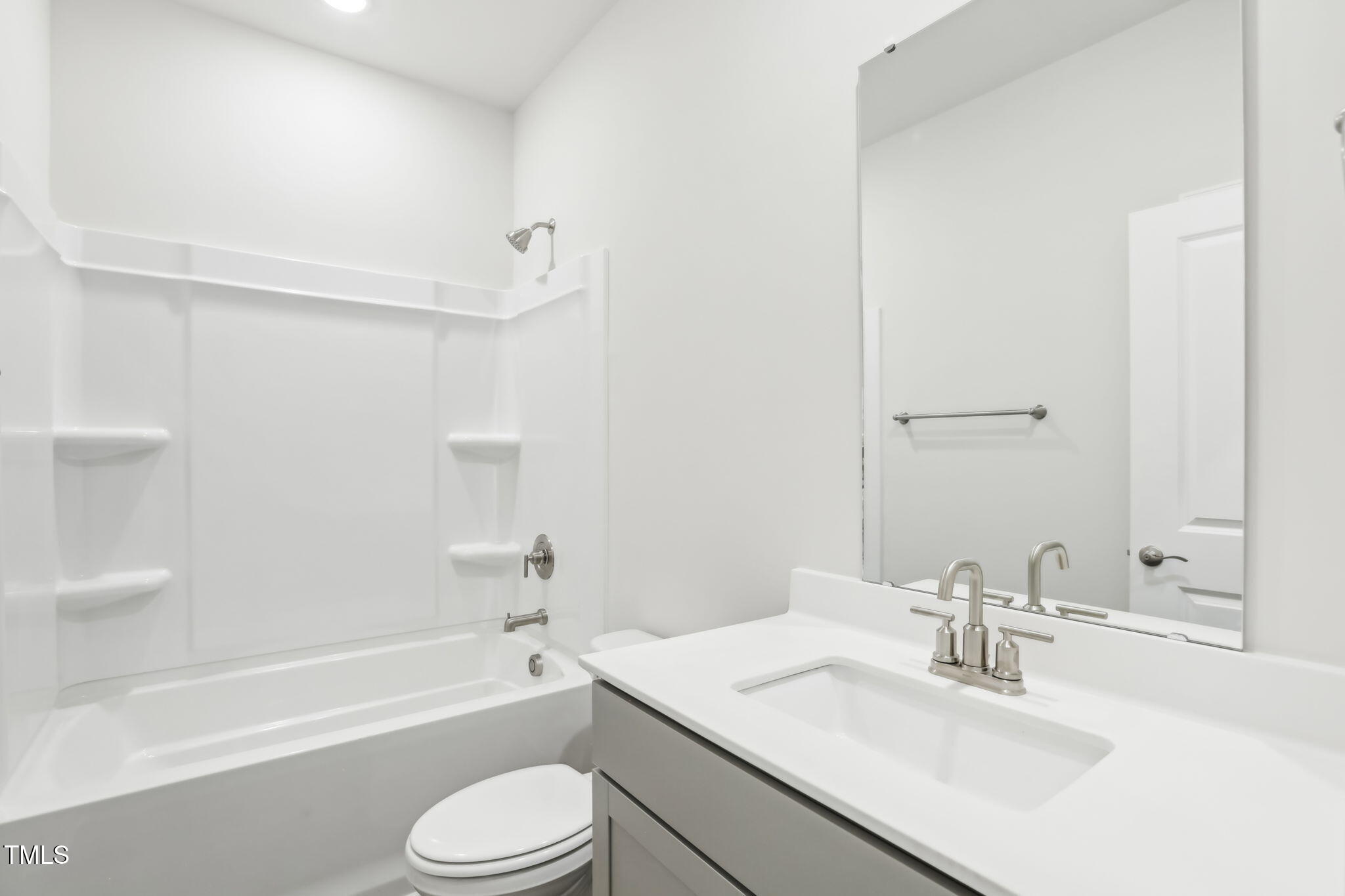 185 White Birch Lane Angier, NC 27501 - Photo 23 of 27 a bathroom with a bathtub shower sink vanity mirror and toilet