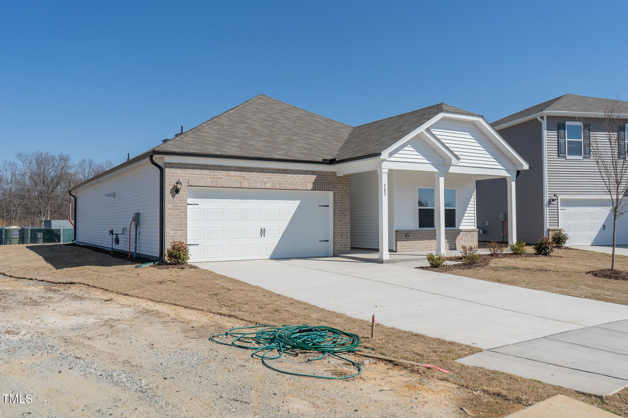 185 White Birch Lane Angier, NC 27501 - Photo 3 of 27 a front view of a house with a yard and garage