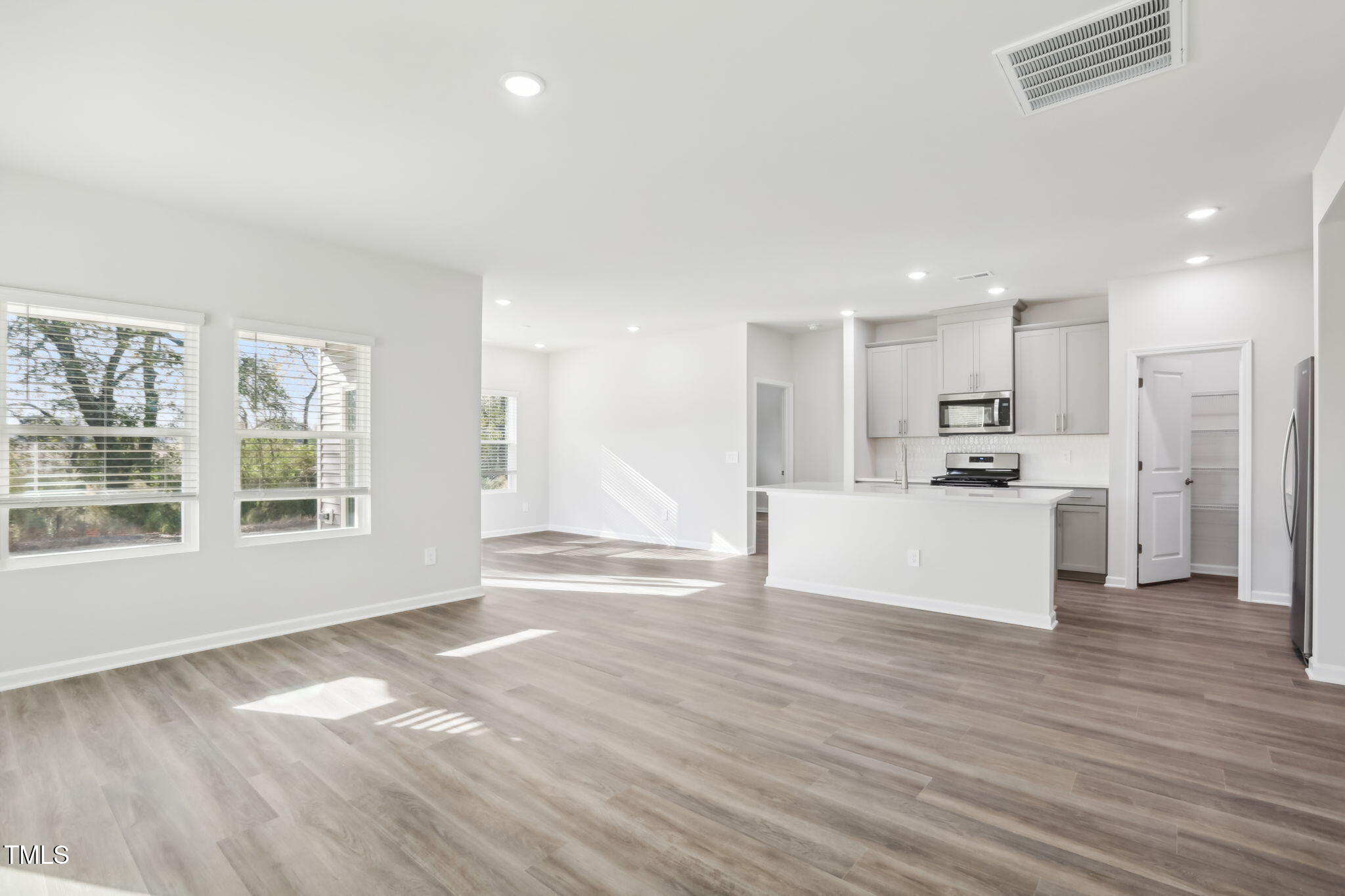 185 White Birch Lane Angier, NC 27501 - Photo 9 of 27 a view of kitchen with wooden floor and window
