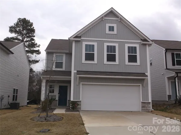 a front view of a house with garage
