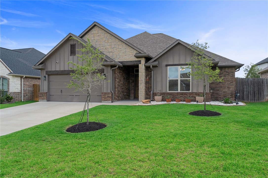 a front view of house with a garden