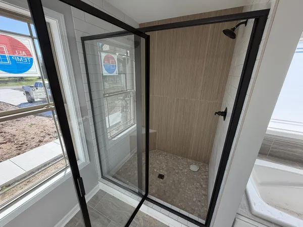 a bathroom with a glass door and a glass door