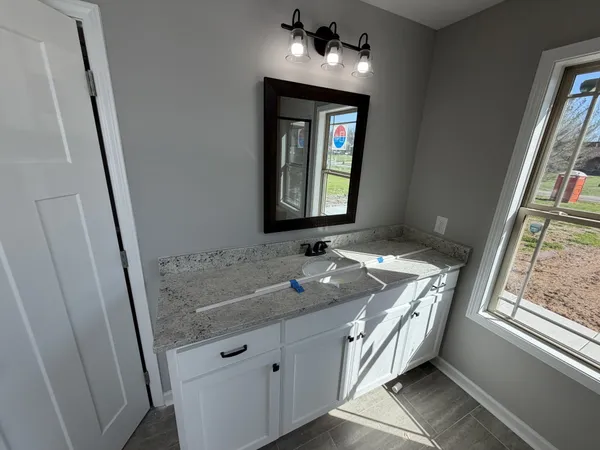 a bathroom with a sink a vanity and a mirror