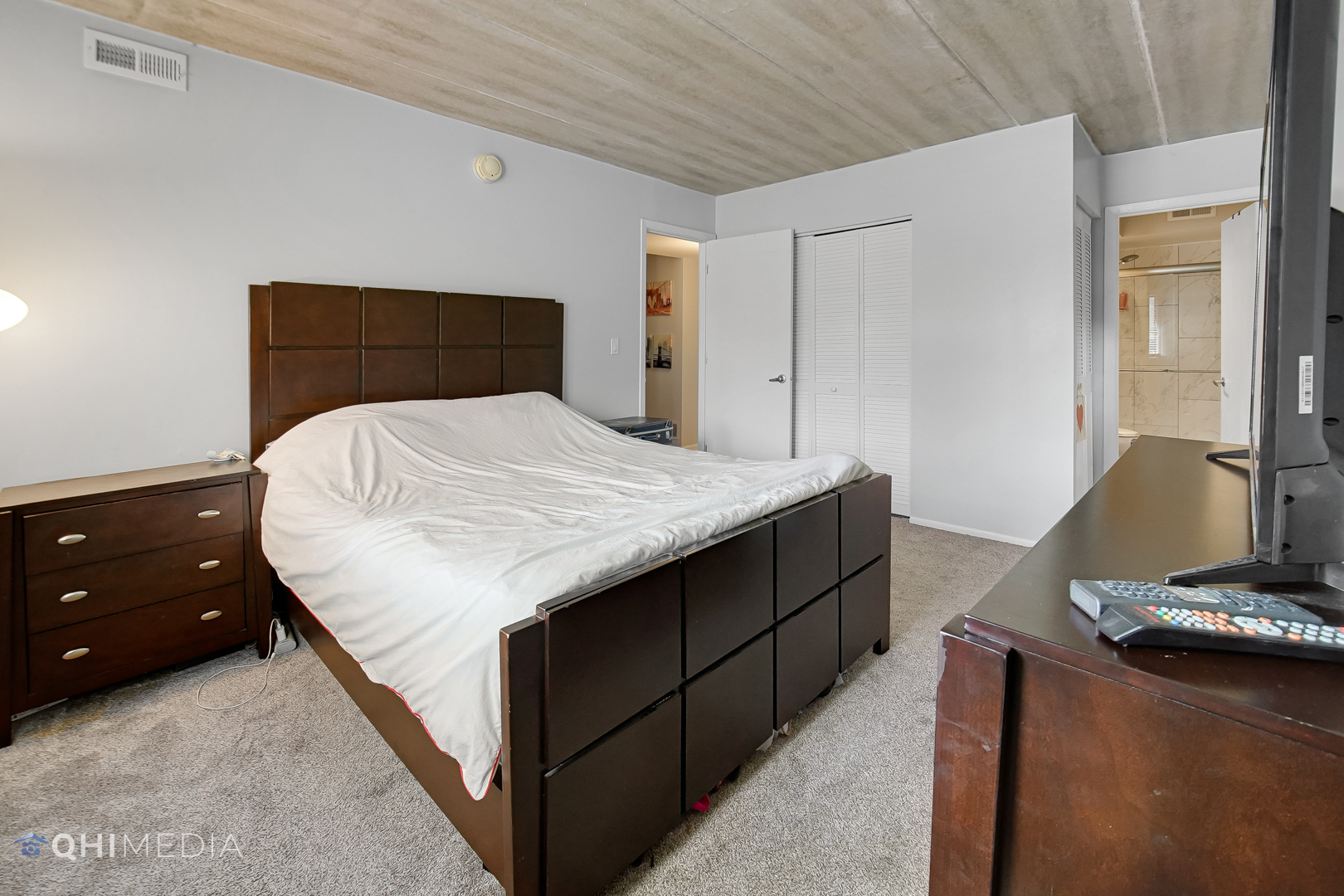 484 Timber Ridge Drive, Unit 106 Carol Stream, IL 60188 - Photo 12 of 23 a bedroom with a bed and wooden floor