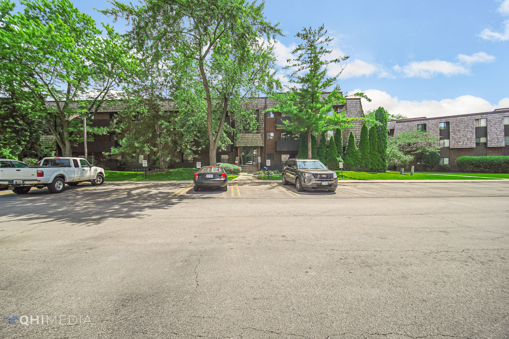 484 Timber Ridge Drive, Unit 106 Carol Stream, IL 60188 - Photo 16 of 23 a car parked on the side of the road