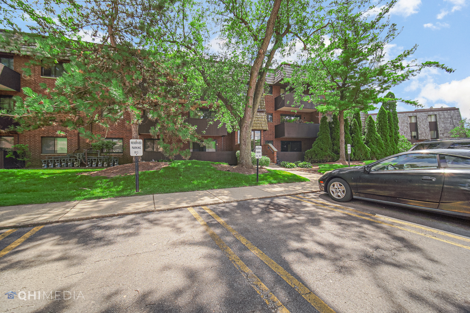 484 Timber Ridge Drive, Unit 106 Carol Stream, IL 60188 - Photo 17 of 23 a view of a street with a car parked in front of it