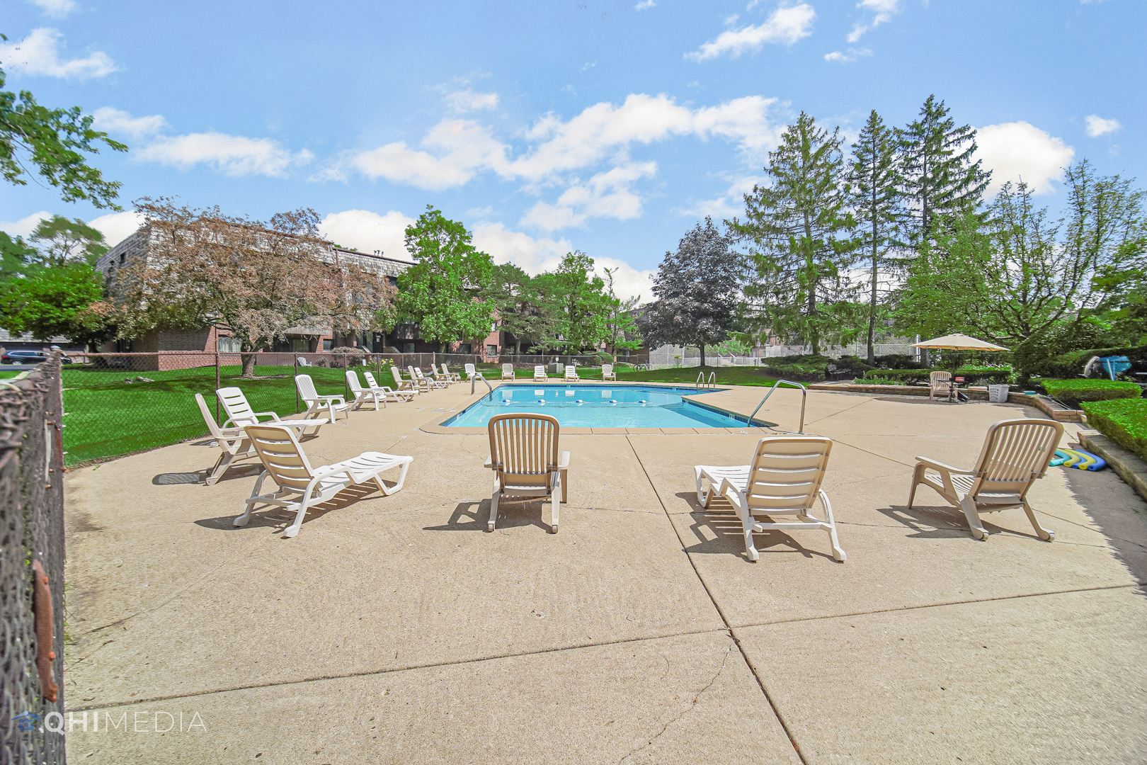 484 Timber Ridge Drive, Unit 106 Carol Stream, IL 60188 - Photo 22 of 23 a view of a lake with table and chairs