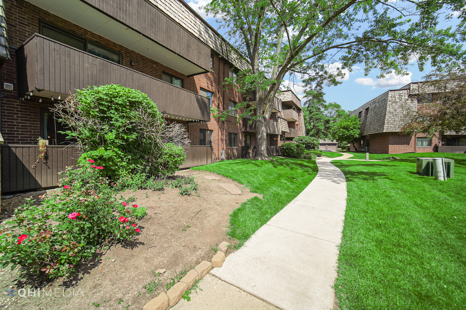 484 Timber Ridge Drive, Unit 106 Carol Stream, IL 60188 - Photo 23 of 23 a view of a garden with flowers