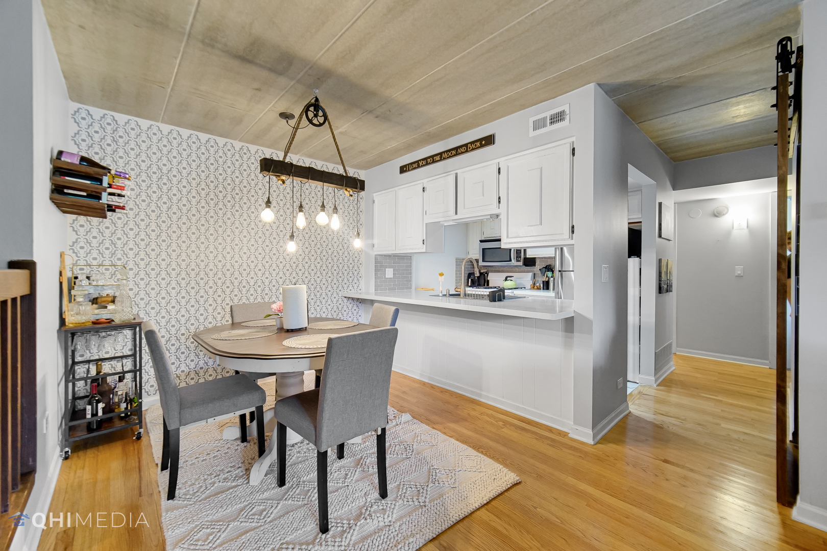 484 Timber Ridge Drive, Unit 106 Carol Stream, IL 60188 - Photo 3 of 23 a kitchen with kitchen island a dining table chairs stainless steel appliances and cabinets