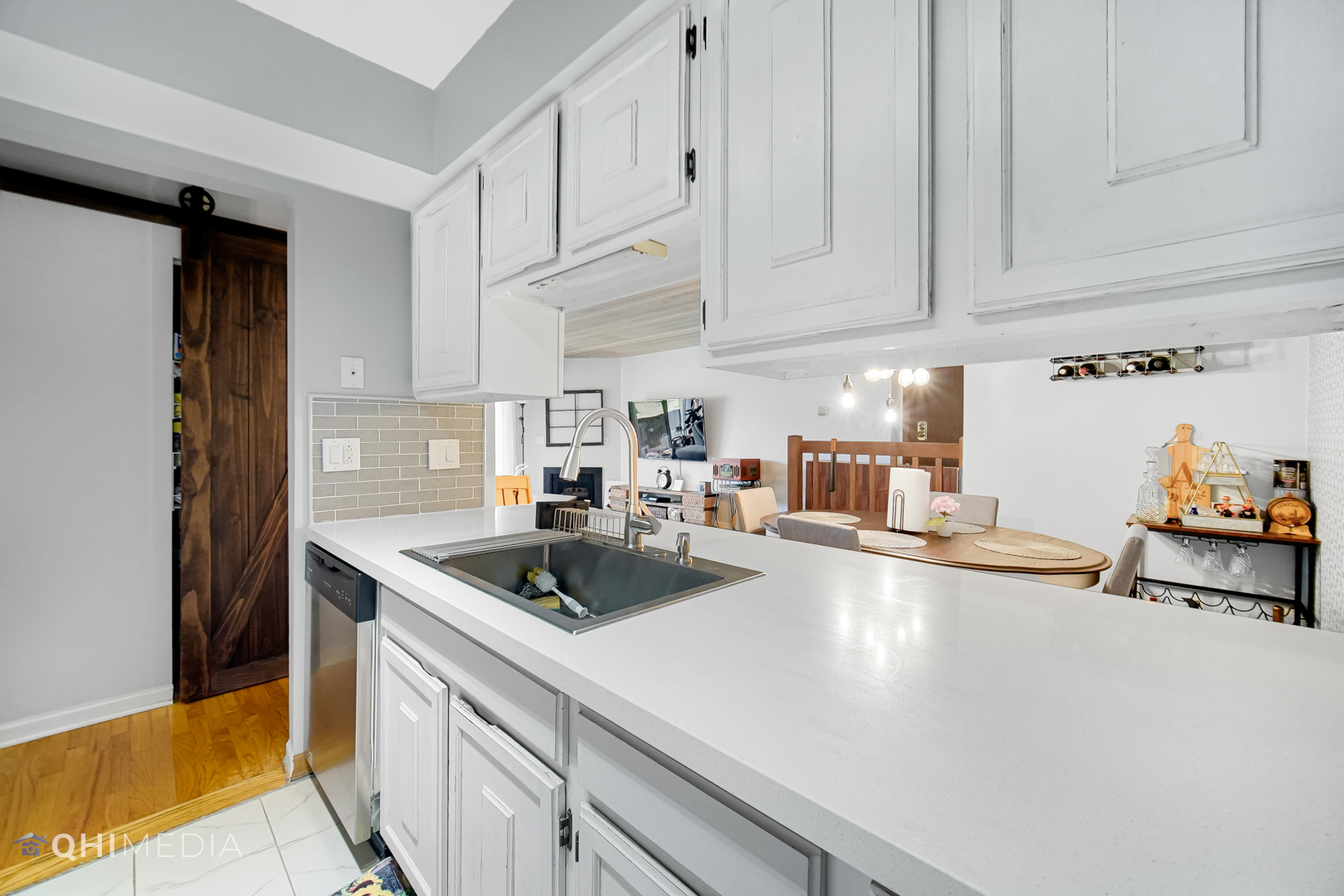 484 Timber Ridge Drive, Unit 106 Carol Stream, IL 60188 - Photo 6 of 23 a kitchen with stainless steel appliances granite countertop a sink and a white cabinets