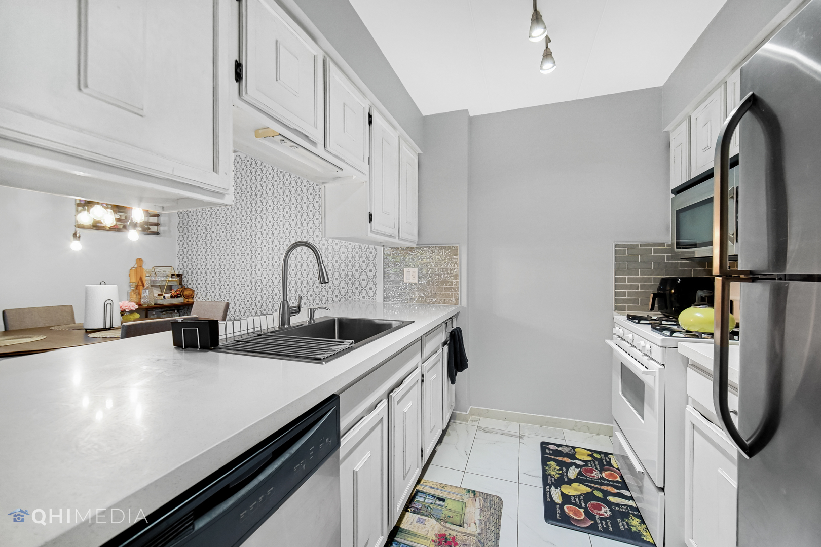 484 Timber Ridge Drive, Unit 106 Carol Stream, IL 60188 - Photo 7 of 23 a kitchen with stainless steel appliances a sink and cabinets