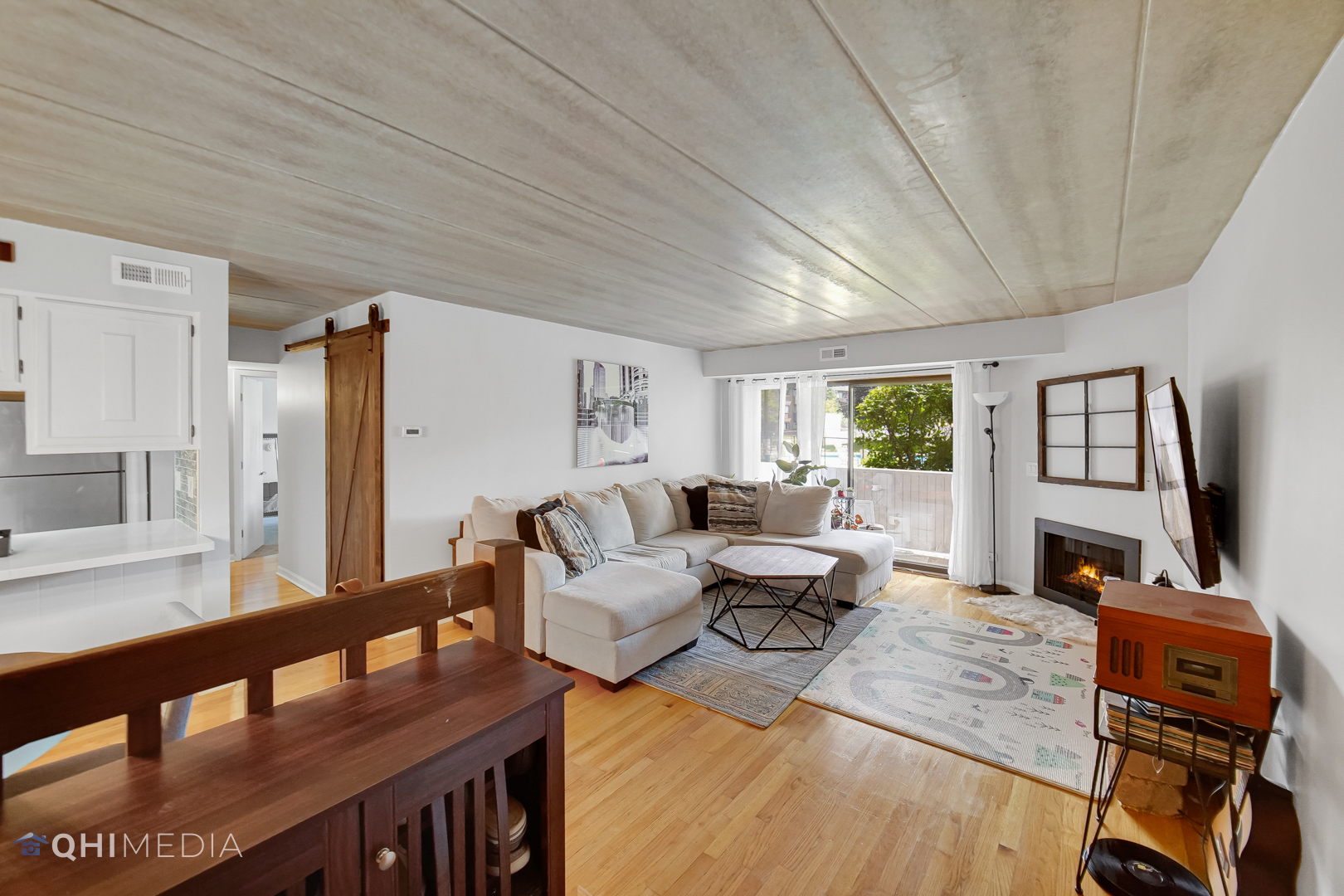 484 Timber Ridge Drive, Unit 106 Carol Stream, IL 60188 - Photo 9 of 23 a living room with furniture and a flat screen tv