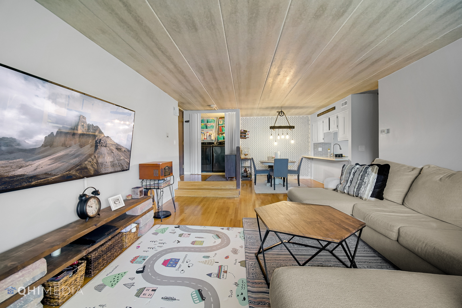 484 Timber Ridge Drive, Unit 106 Carol Stream, IL 60188 - Photo 10 of 23 a living room with furniture and a flat screen tv