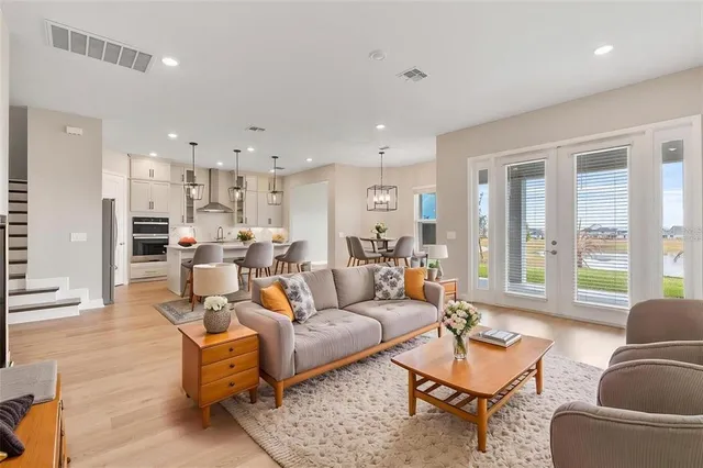 a kitchen with kitchen island granite countertop a refrigerator and microwave