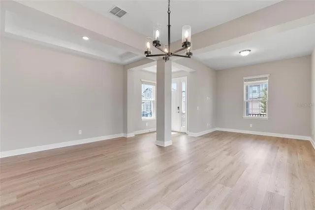 an empty room with windows and closet