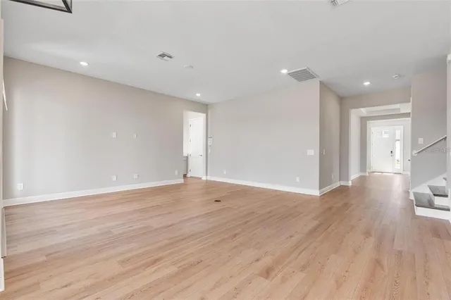 an empty room with a empty space and windows