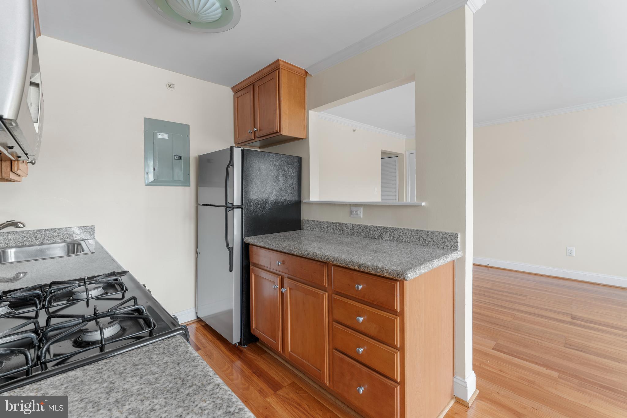 610 Main Street, Unit 511 Laurel, MD 20707 - Photo 11 of 30 a kitchen with a stove and a refrigerator