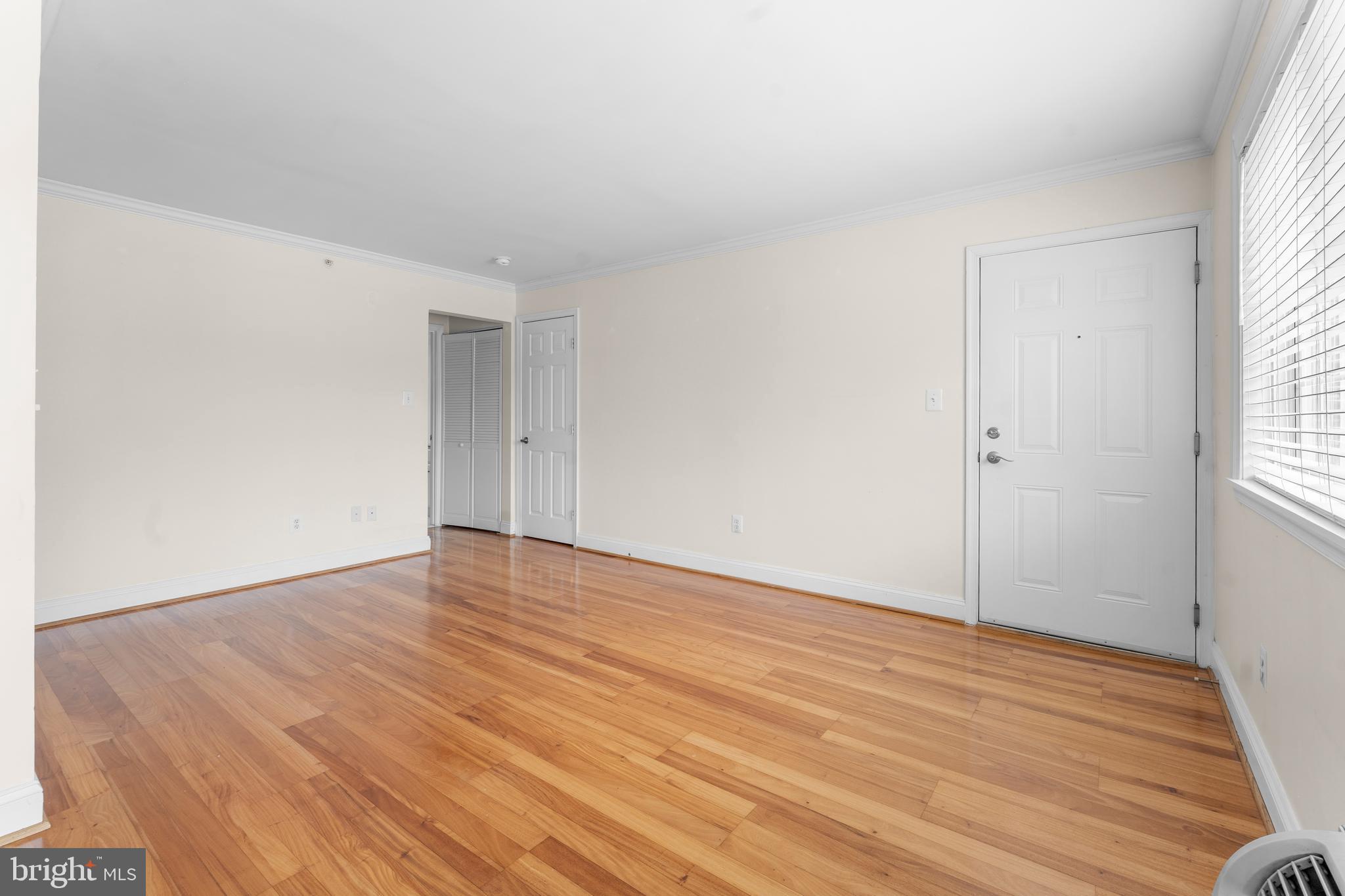 610 Main Street, Unit 511 Laurel, MD 20707 - Photo 6 of 30 an empty room with wooden floor and windows