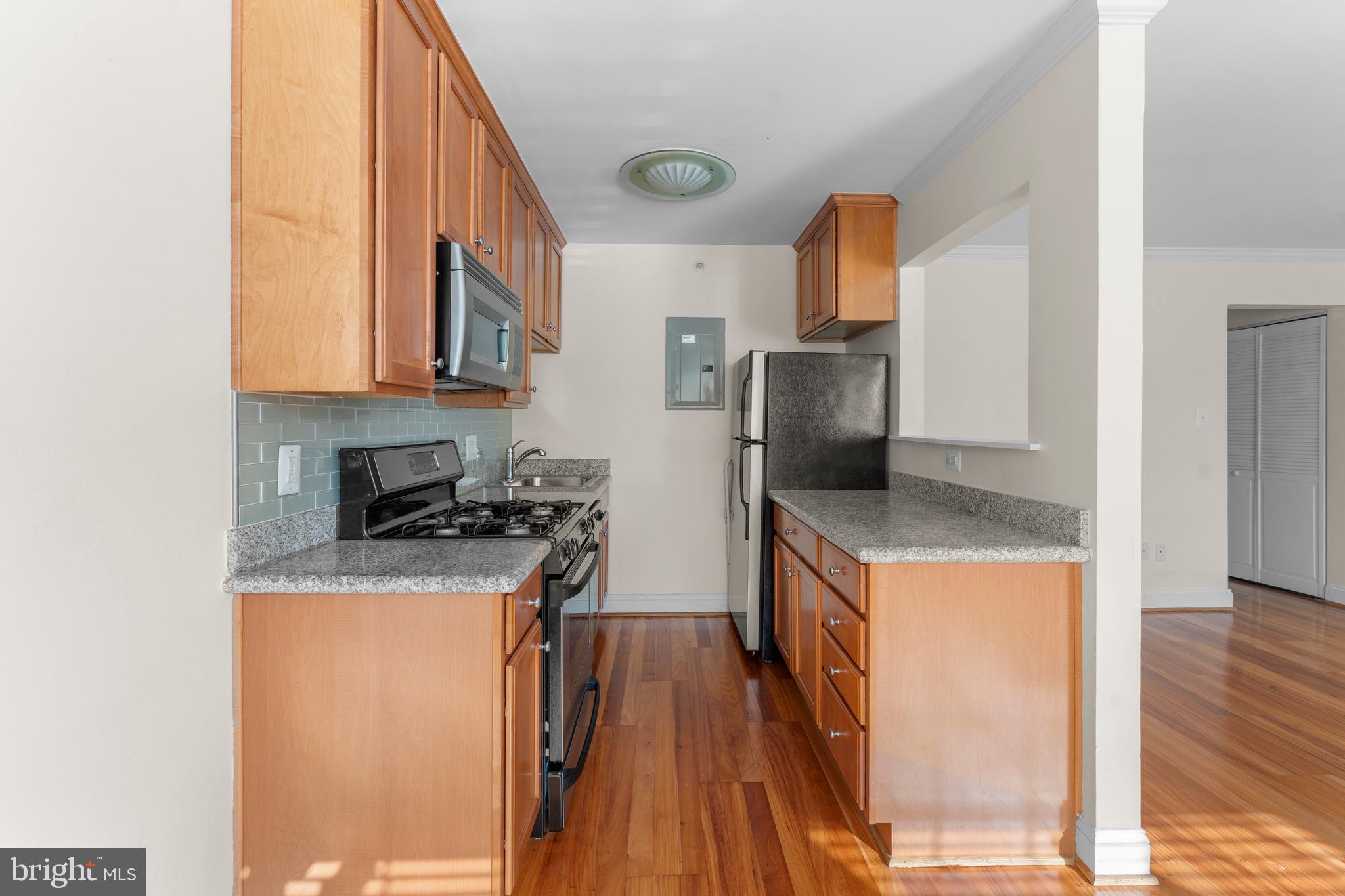 610 Main Street, Unit 511 Laurel, MD 20707 - Photo 10 of 30 a kitchen with stainless steel appliances granite countertop a stove a sink and a refrigerator