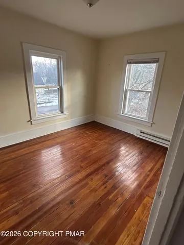 a bathroom with a tub a sink and a large window