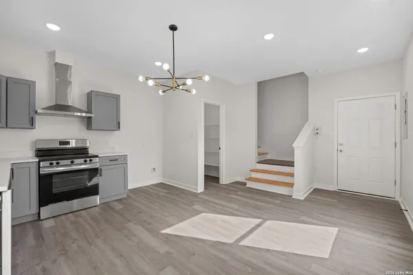 a kitchen with stainless steel appliances a stove a sink and a refrigerator