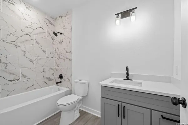 a bathroom with a sink a toilet and a bathtub