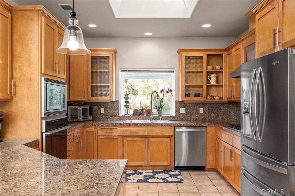 2262 Honey Run Road Chico, CA 95928 - Photo 74 of 74 a kitchen with stainless steel appliances granite countertop a sink stove and refrigerator