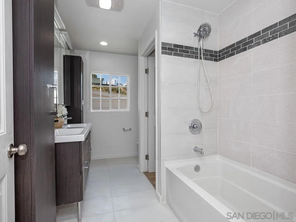 4765 Maple Avenue La Mesa, CA 91942 - Photo 14 of 26 a bathroom with a tub sink shower and mirror