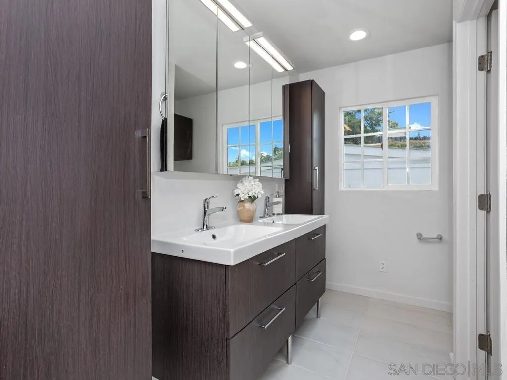 4765 Maple Avenue La Mesa, CA 91942 - Photo 15 of 26 a bathroom with a sink double vanity and a mirror