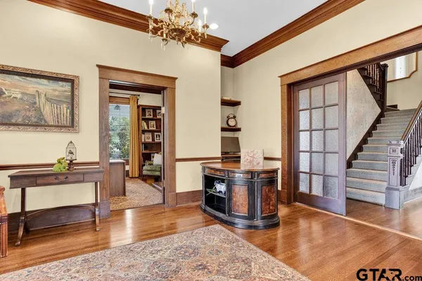 a living room with furniture and a chandelier