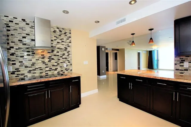 a kitchen with a refrigerator and a sink