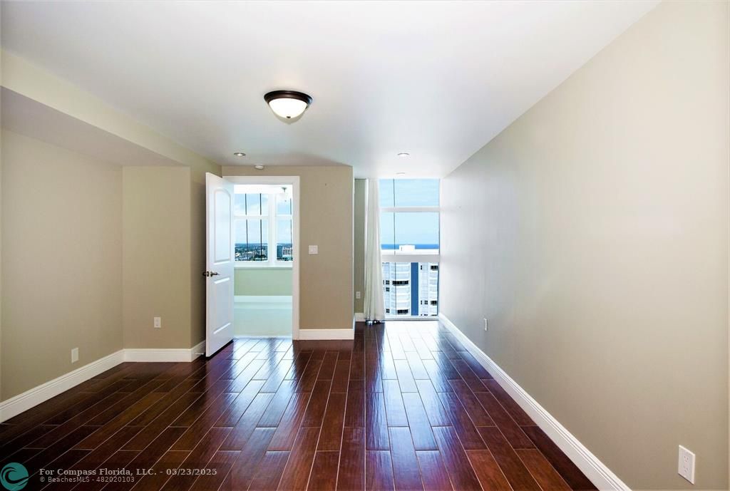 1360 South Ocean Boulevard, Unit 2806 Pompano Beach, FL 33062 - Photo 18 of 37 a view of a big room with wooden floor and windows