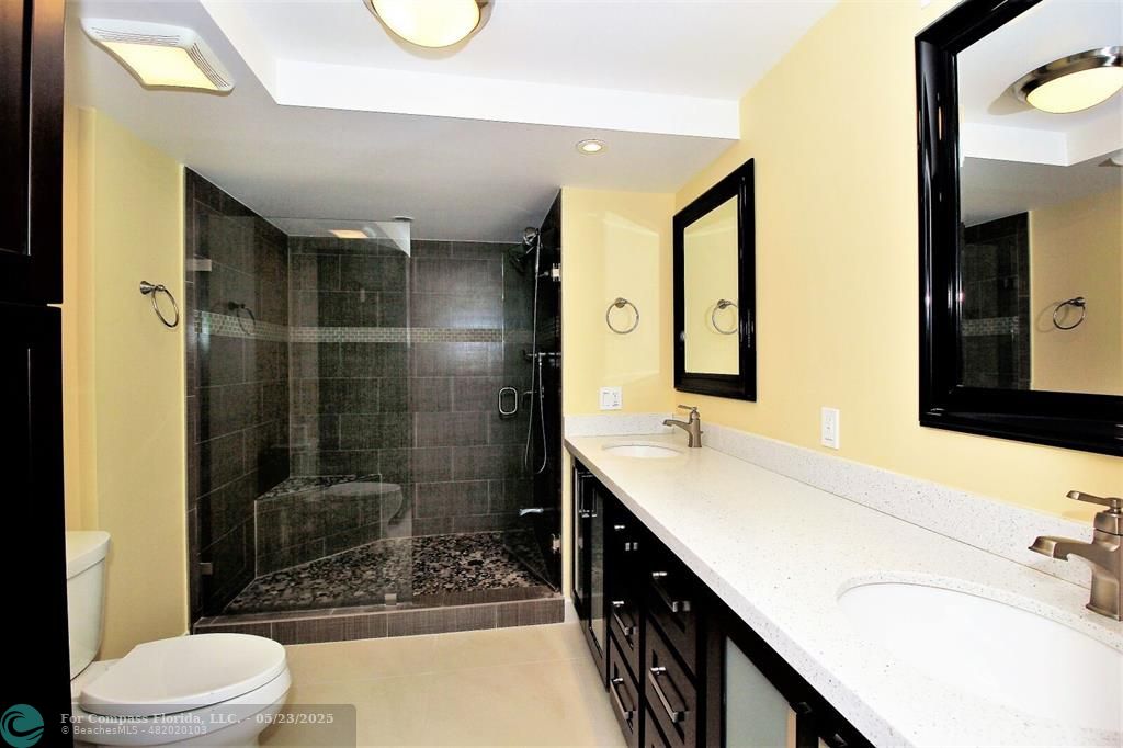 1360 South Ocean Boulevard, Unit 2806 Pompano Beach, FL 33062 - Photo 21 of 37 a bathroom with a double vanity sink toilet and shower