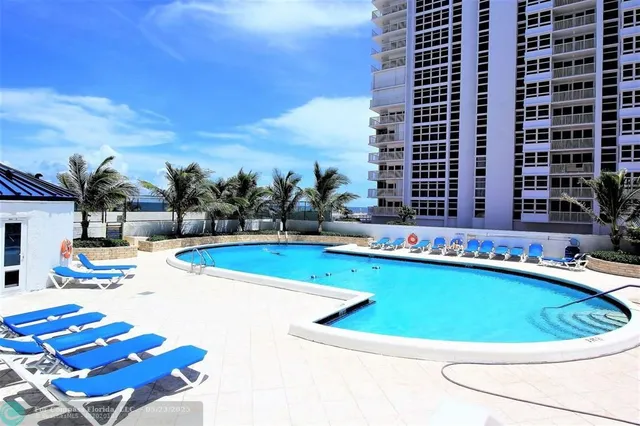 a view of swimming pool with outdoor seating