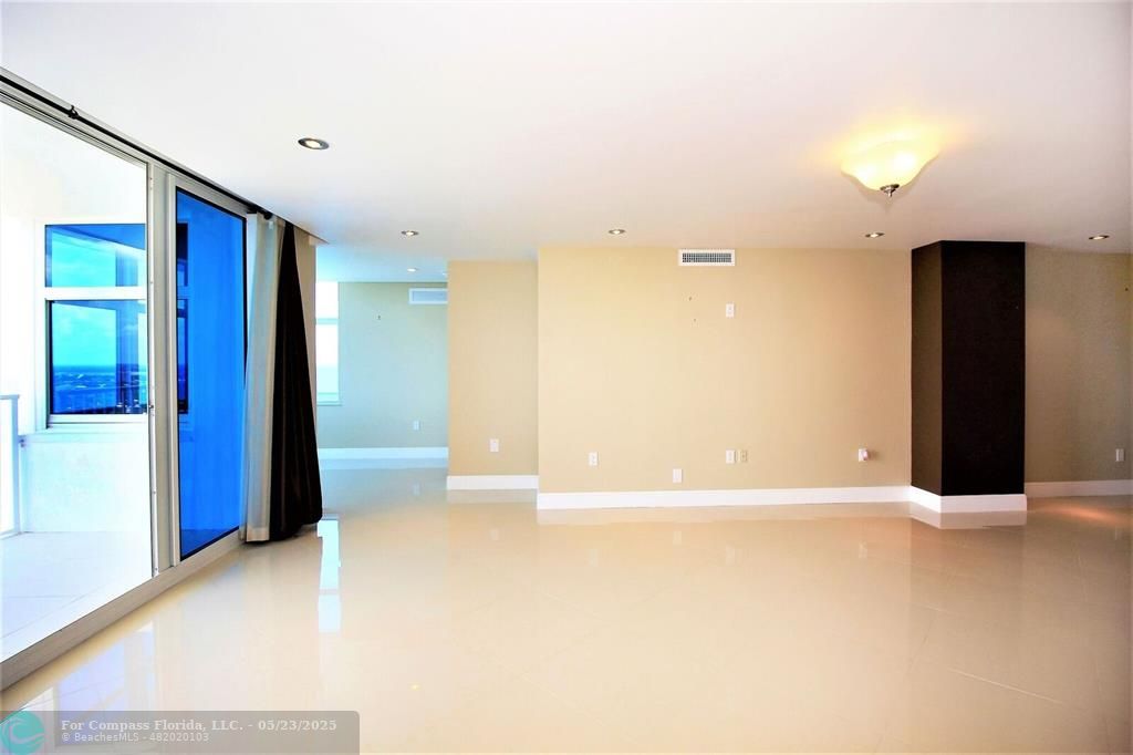 1360 South Ocean Boulevard, Unit 2806 Pompano Beach, FL 33062 - Photo 6 of 37 a view of an empty room with wooden floor