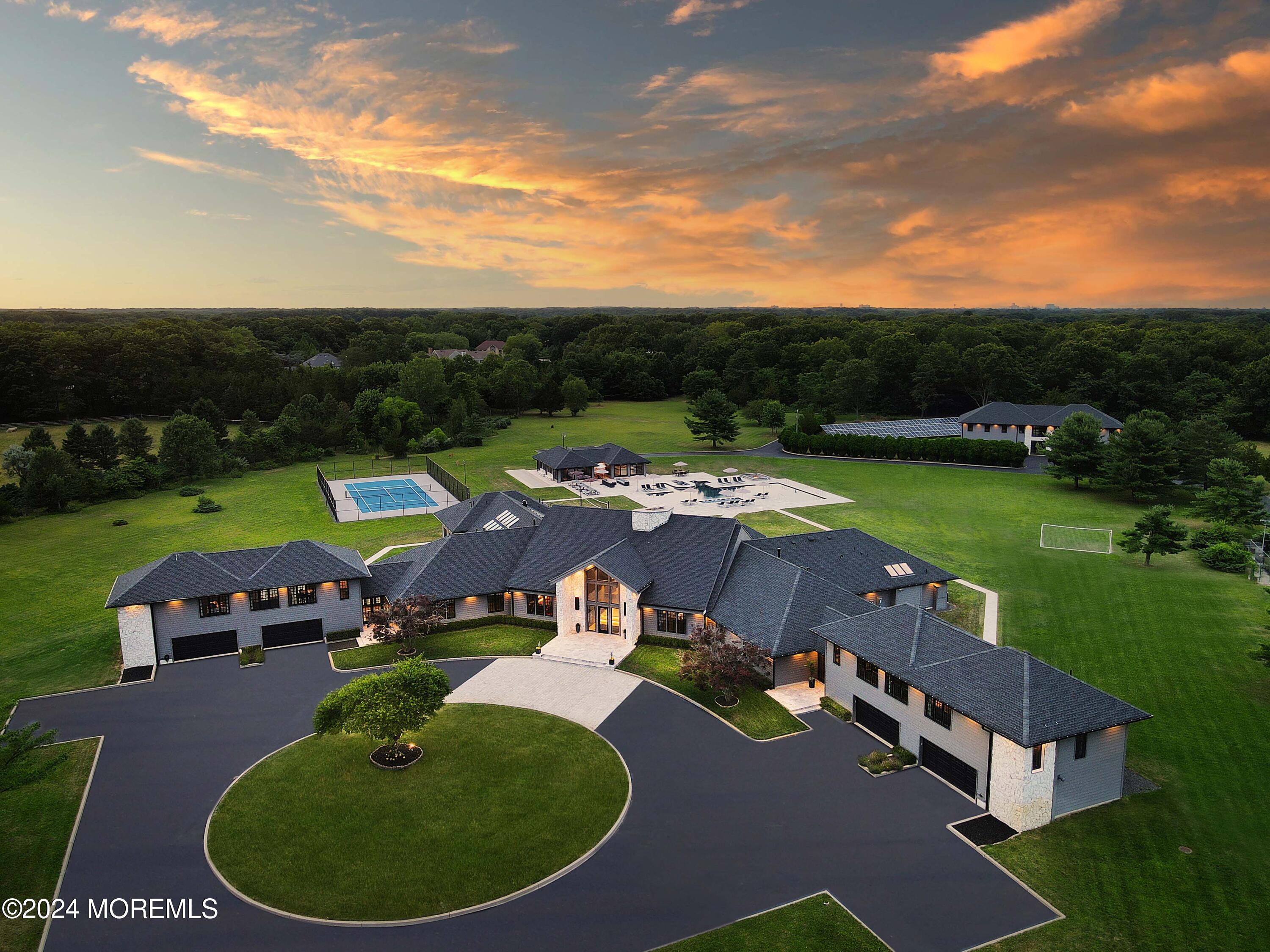 an aerial view of a house with outdoor space pool basket ball court and outdoor seating