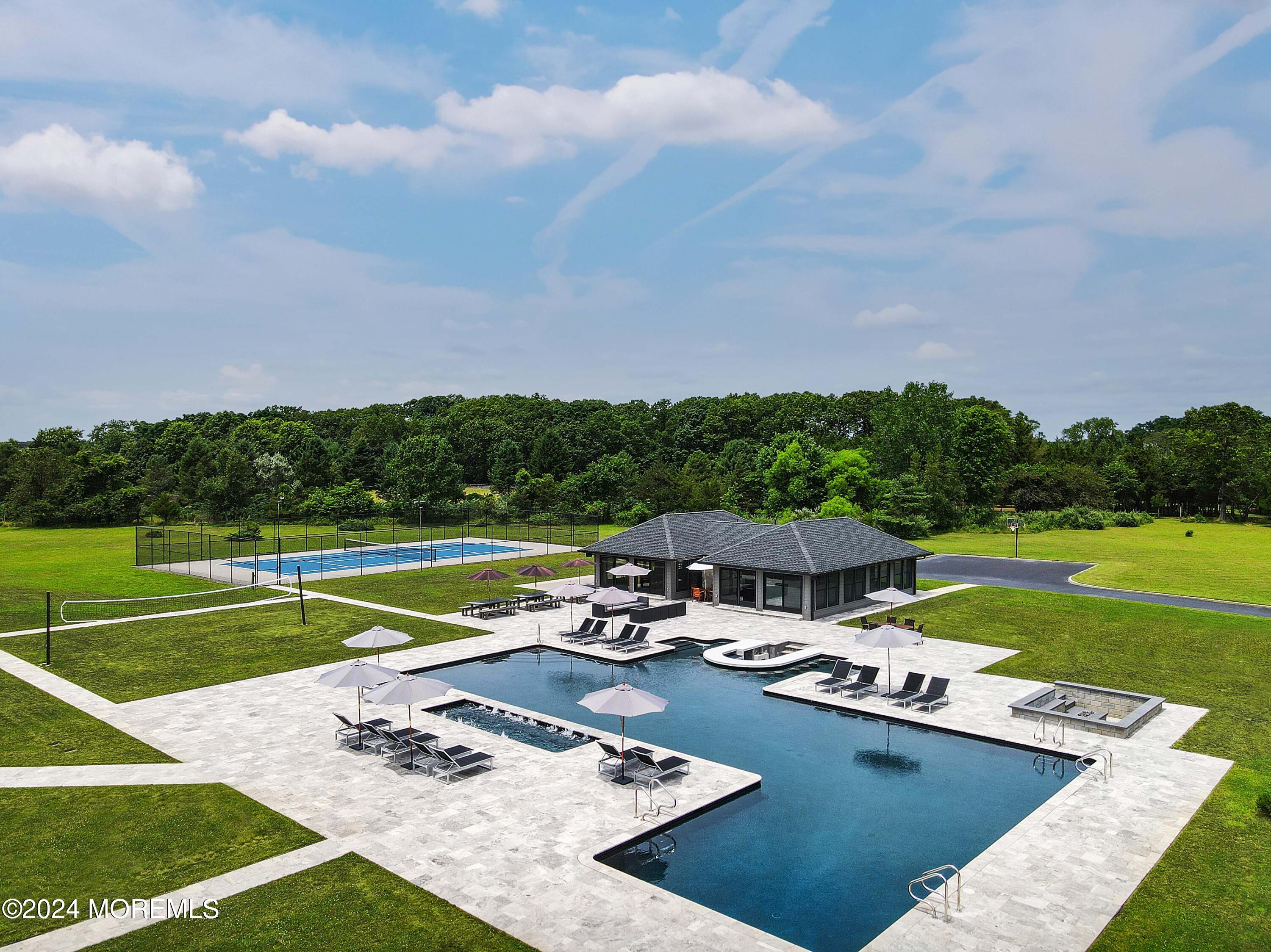 1980 Campbell Road Wall, NJ 07719 - Photo 106 of 110 a view of a swimming pool and lounge chairs in back yard of the house