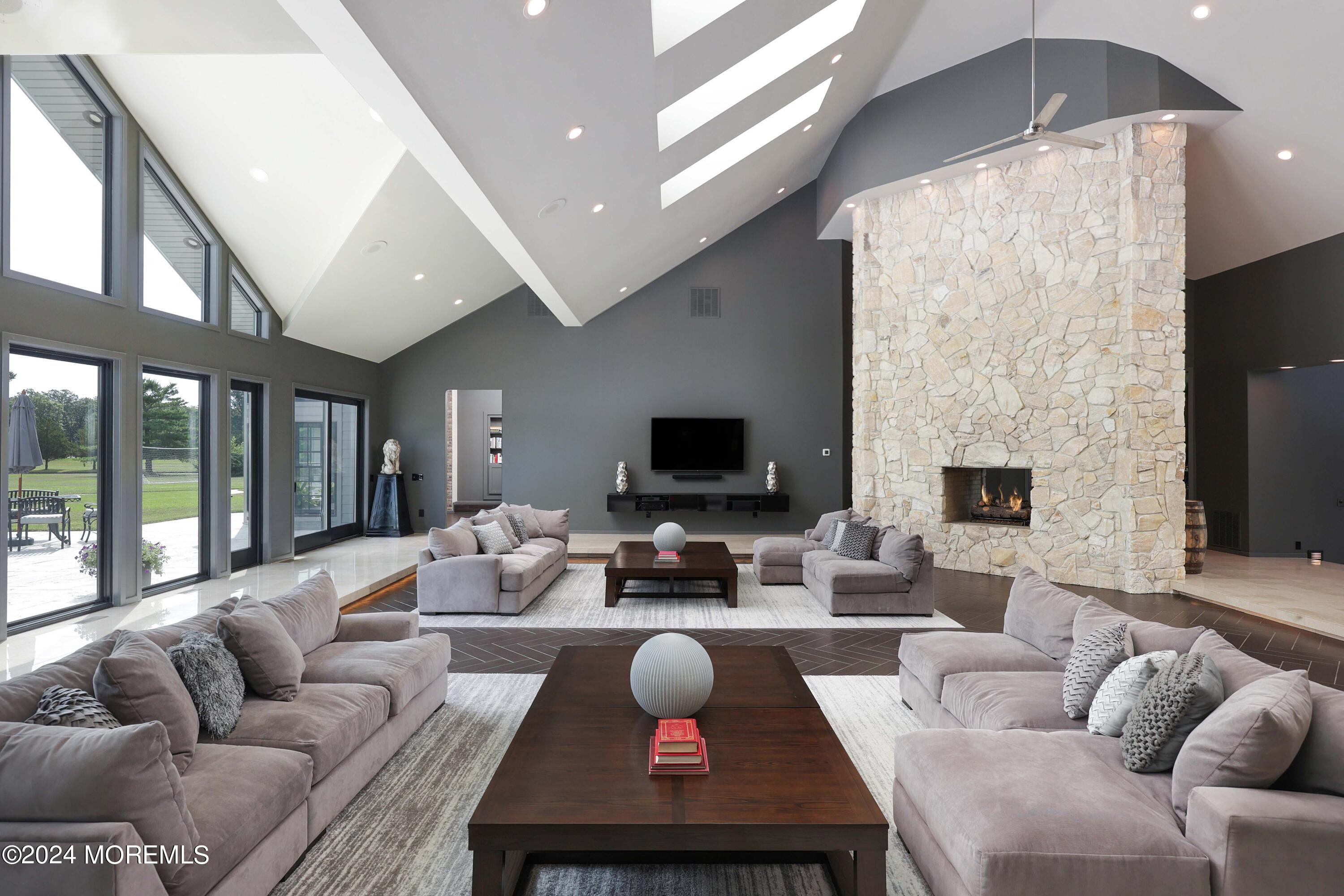 1980 Campbell Road Wall, NJ 07719 - Photo 15 of 110 a living room with furniture a fireplace and a flat screen tv