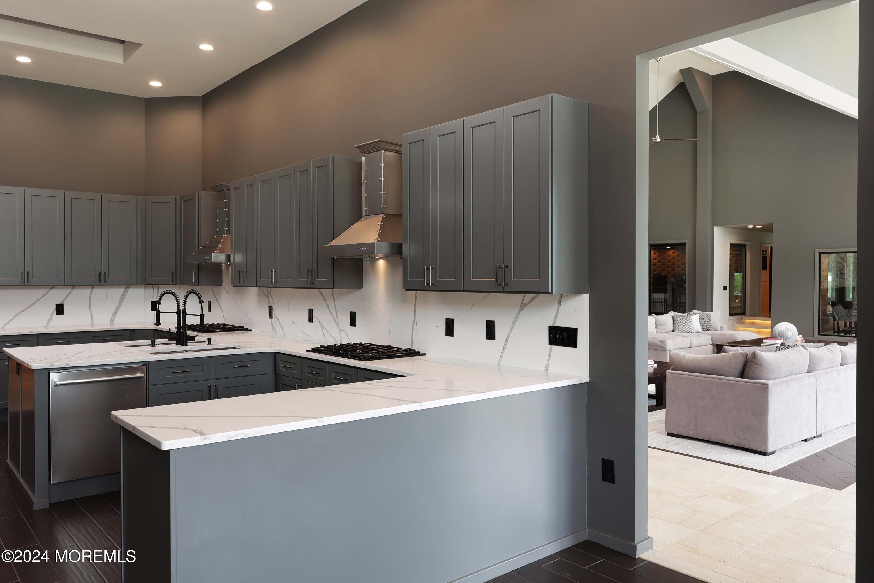 1980 Campbell Road Wall, NJ 07719 - Photo 31 of 110 a kitchen with a sink and a stove top oven with wooden floor