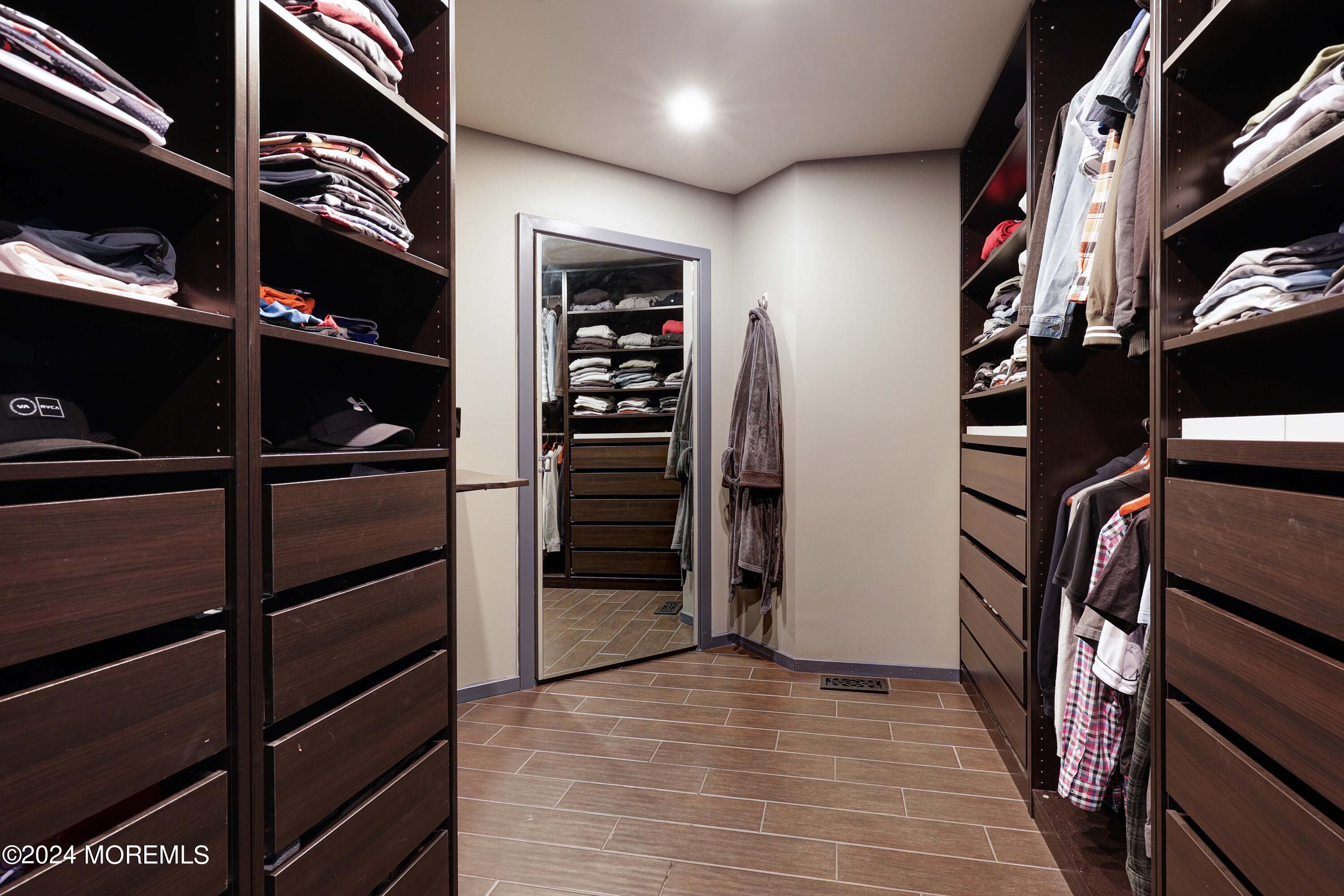 1980 Campbell Road Wall, NJ 07719 - Photo 49 of 110 a view of walk in closet with clothes and shoes