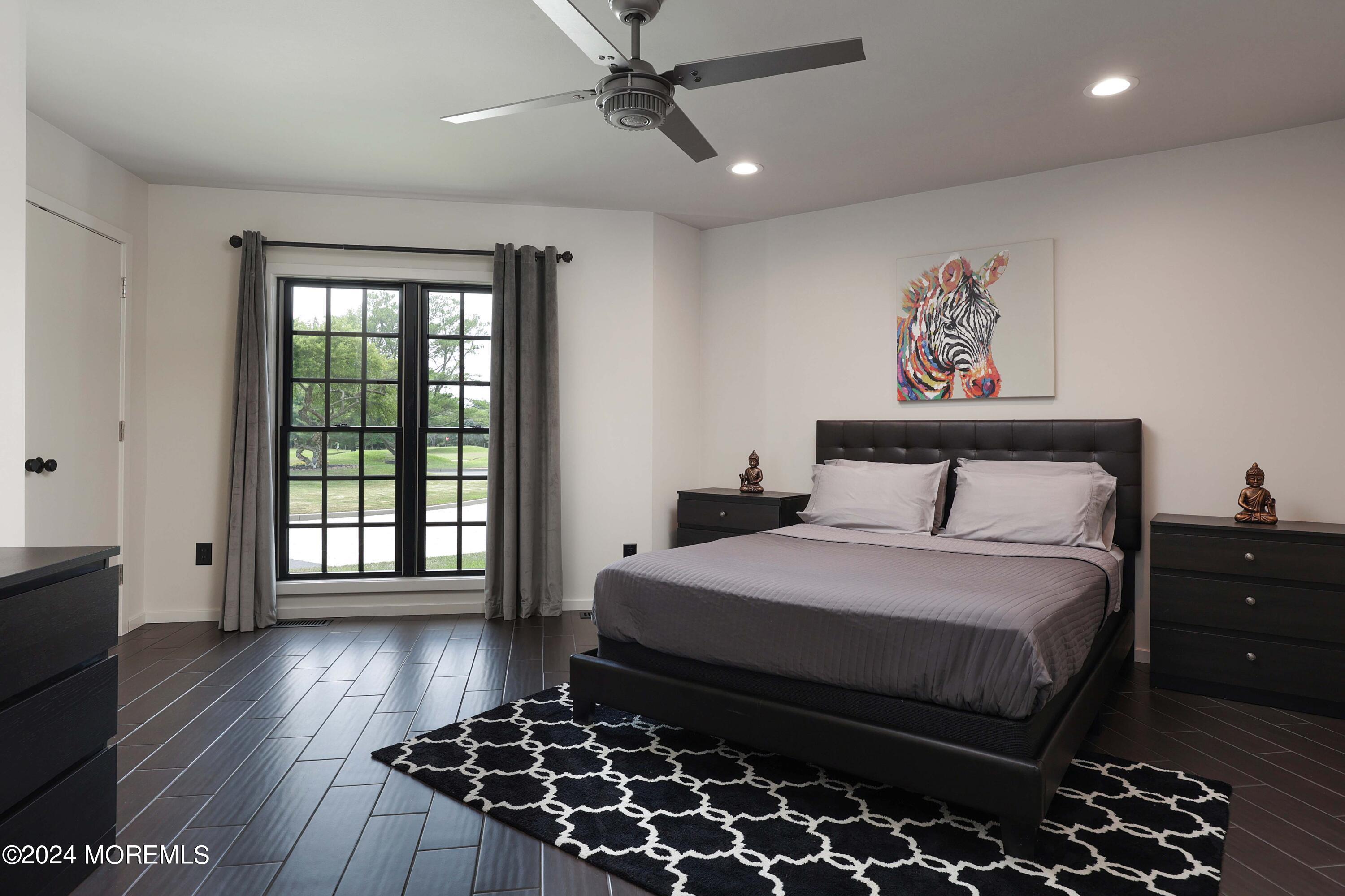 1980 Campbell Road Wall, NJ 07719 - Photo 51 of 110 a bedroom with a bed and wooden floor