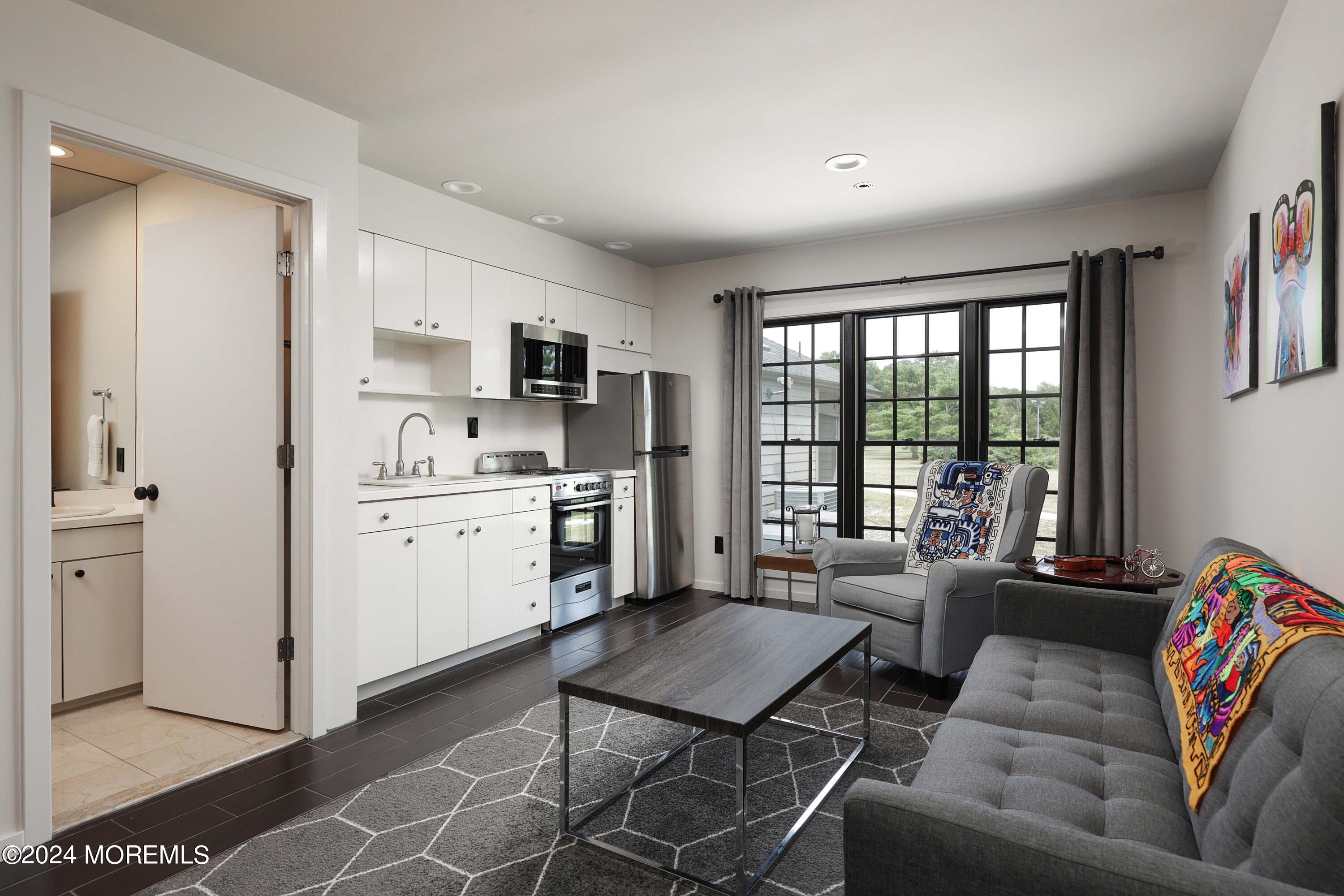 1980 Campbell Road Wall, NJ 07719 - Photo 54 of 110 a living room with furniture and a kitchen area