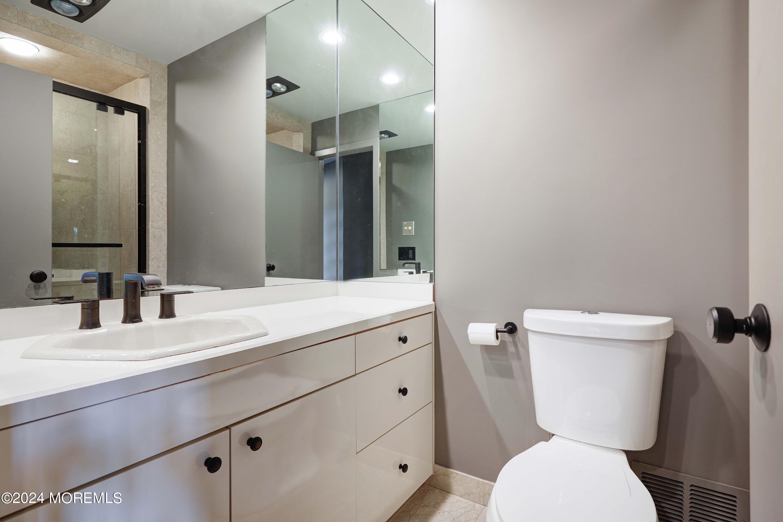 1980 Campbell Road Wall, NJ 07719 - Photo 61 of 110 a bathroom with a toilet a sink and mirror