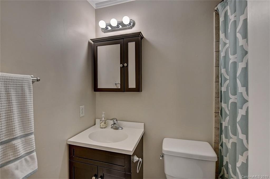 3508 Colony Road, Unit F Charlotte, NC 28211 - Photo 22 of 26 a bathroom with a toilet sink and mirror